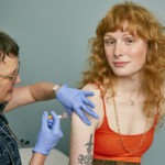 Woman receiving a vaccine in a doctor's office, By: SELF Magazine , Source: flickr. License: by | //creativecommons.org/licenses/by/2.0/