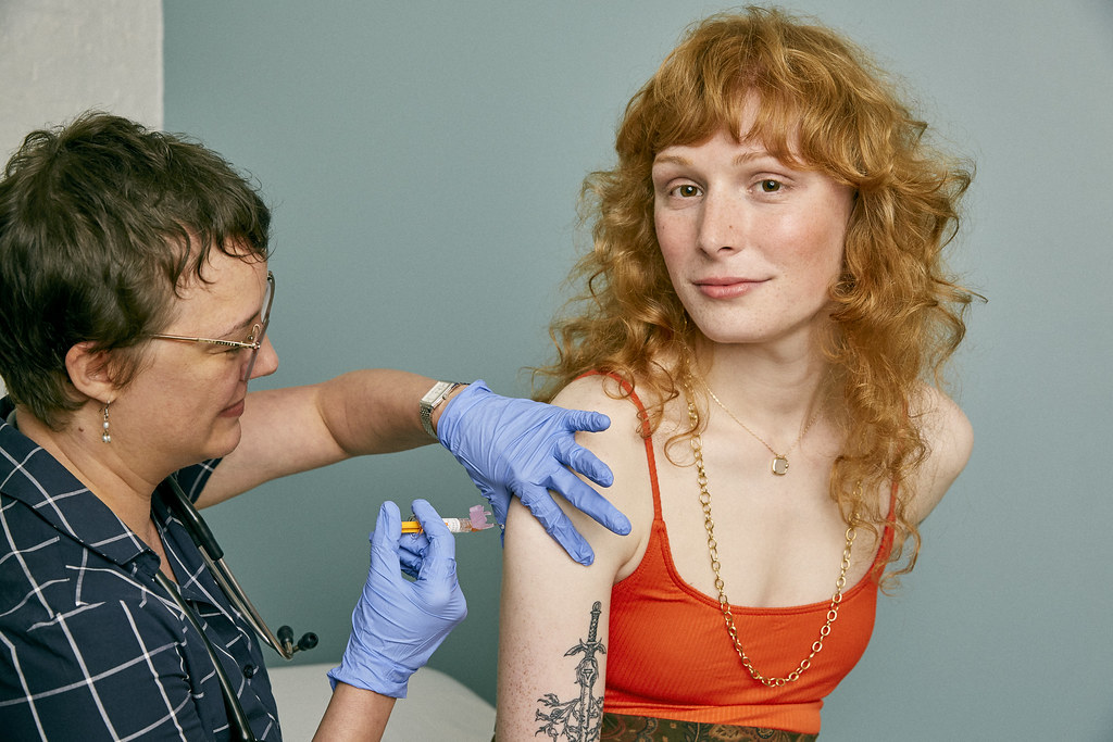 Woman receiving a vaccine in a doctor's office, By: SELF Magazine , Source: flickr. License: by | //creativecommons.org/licenses/by/2.0/